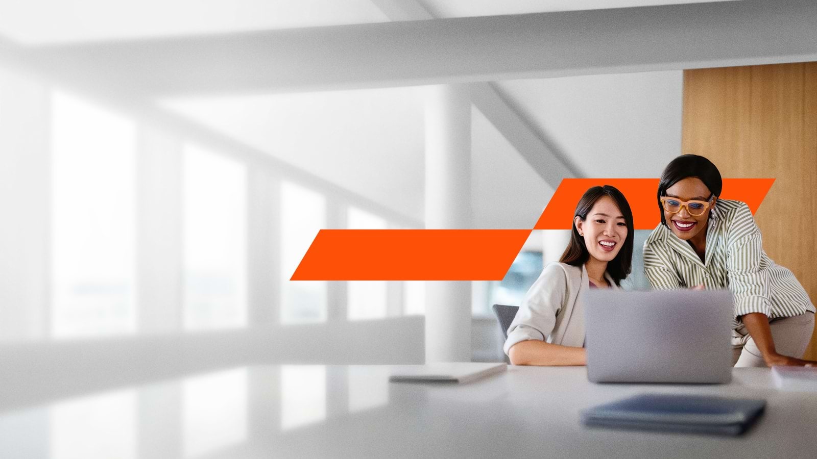 Two women looking at a laptop at work