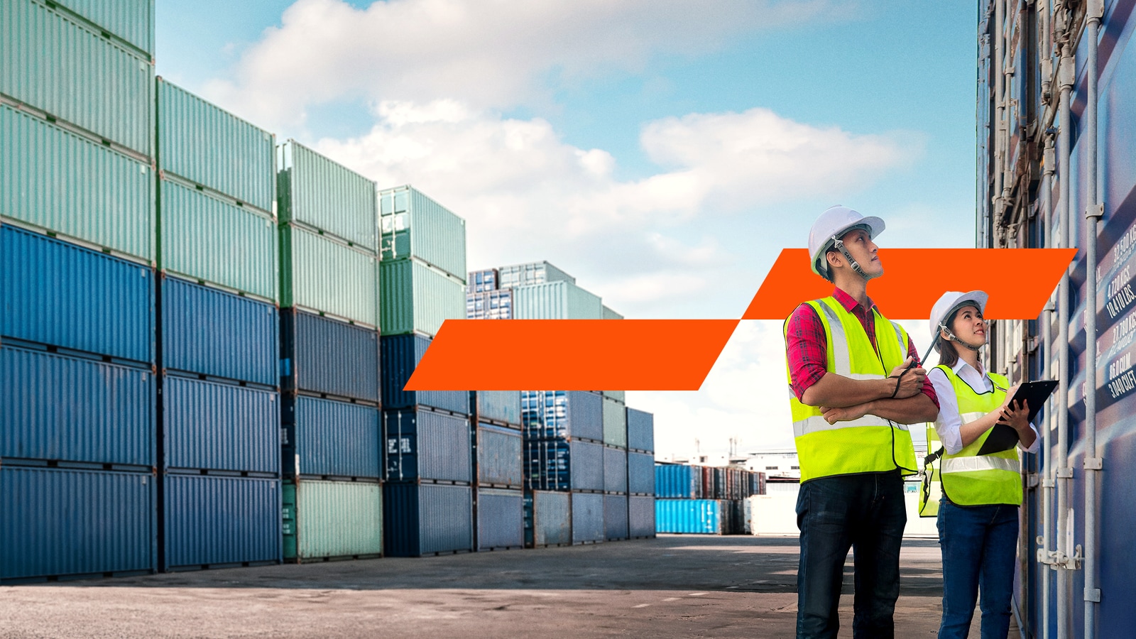 Two workers next to transportation containers